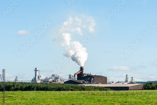 Biomass heat plant in Europe emitting white smoke.
