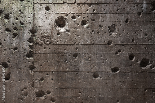 Foto Bunker wall with shell holes / Texture / Background