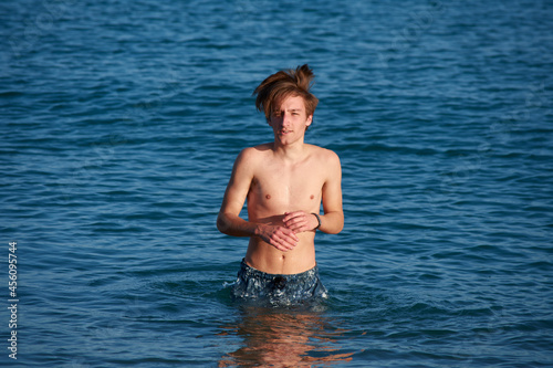 A portrait of a young fit caucasian male in the sea