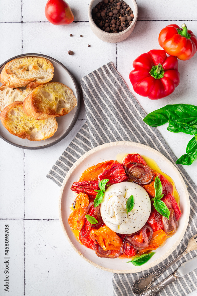 Burrata cheese with baked tomatoes, pepper, red onion and fresh basil Burrata cheese with baked tomatoes, pepper, red onion and fresh basil