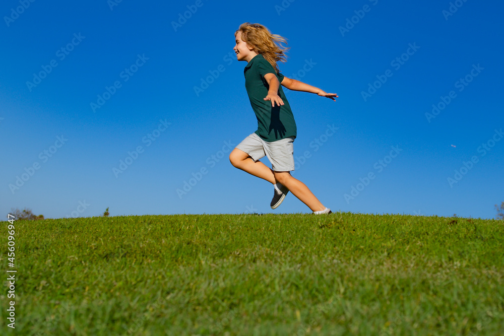 Sweet, happy child boy running playing on a grass in a park at a spring. Active healthy outdoor sport. Fun activity. Sweet, happy child boy running playing on a grass in a park at a spring. Active healthy outdoor sport. Fun activity.