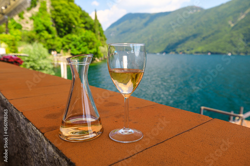rose wine by the lakefront of Lugano city in Switzerland. Romantic appetizer in Ticino Canton on Swiss Lake Lugano. Olive trees pathway of Lugano in Switzerland.