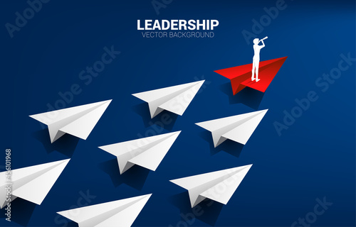 Silhouette of businessman looking through telescope on red origami paper airplane leading group of white. Business Concept of leadership and vision mission.
