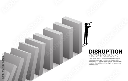 Silhouette of businessman standing looking through telescope at the end of domino collapse. Concept of business industry disrupt