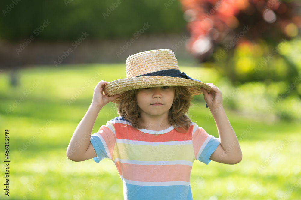Portrait of little boy in straw hat. Concept of kids face. Head shoot summer children portrait.