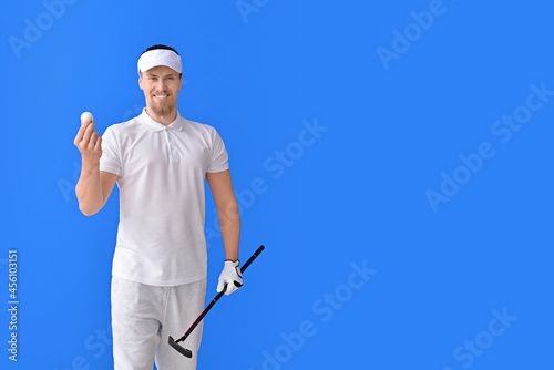 Handsome male golfer on color background