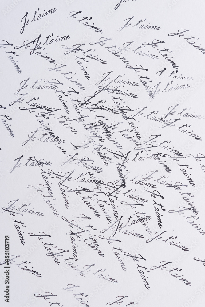 rubber stamp background with the french expression "je t'aime" stamped