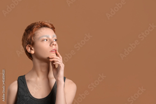 Teenage boy with dyed eyebr...