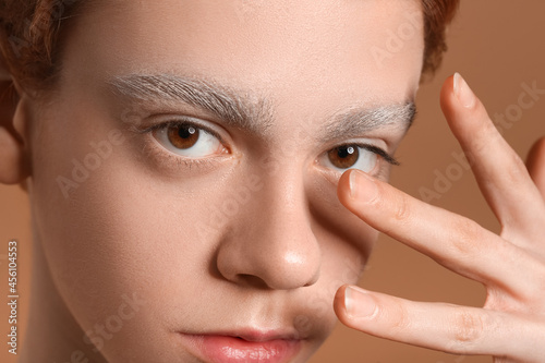 Teenage boy with dyed eyebr...