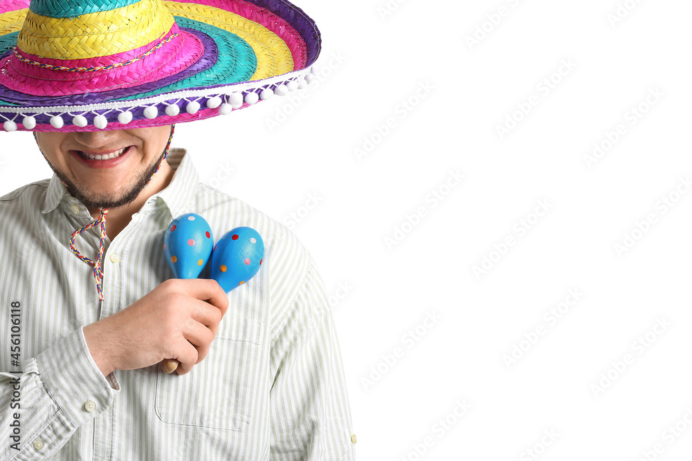 Young Mexican man in sombrero hat and with maracas on white background ...