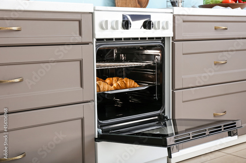 Modern furniture with electric oven in kitchen