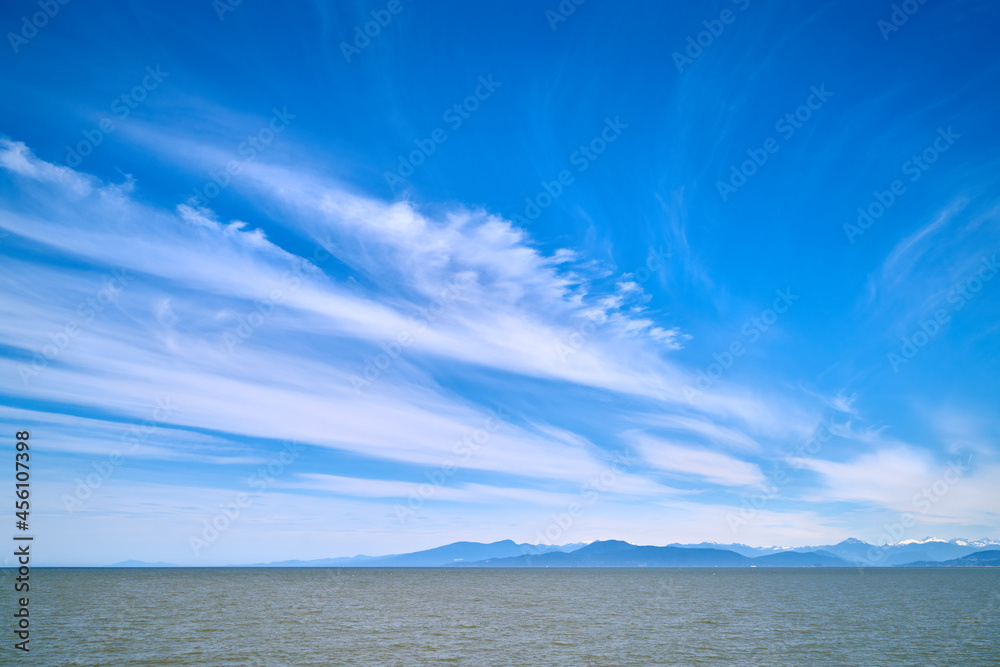 Wispy Clouds over Georgia Strait. Light clouds and blue sky over the Strait of Georgia.

