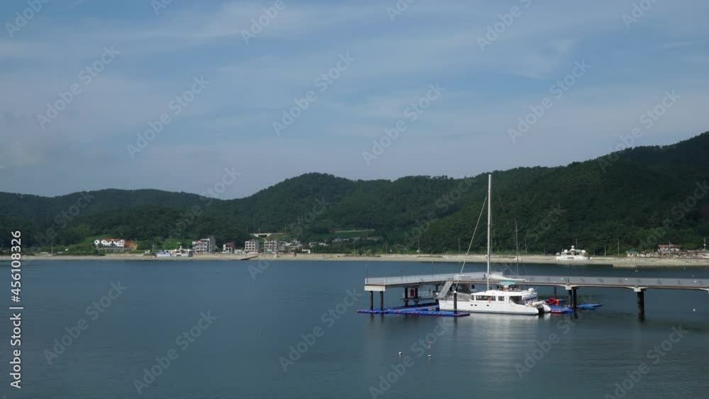 Ferry Boat On A Dock Nearby The Beach In Geonje City South Korea - wide shot Ferry Boat On A Dock Nearby The Beach In Geonje City South Korea - wide shot