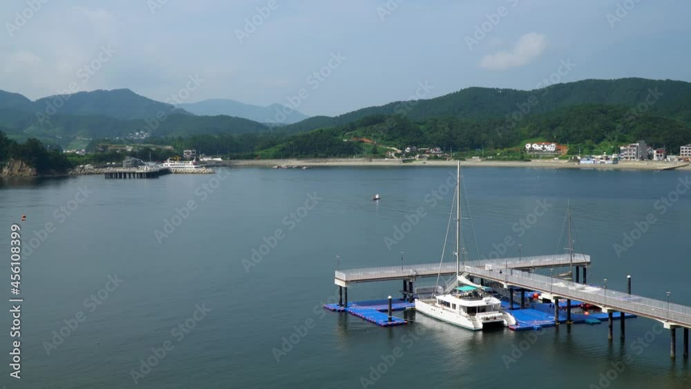 Catamaran Boat Moored In The Jetty Of A Resort In Geojedo Island In South Korea. - wide shot Catamaran Boat Moored In The Jetty Of A Resort In Geojedo Island In South Korea. - wide shot