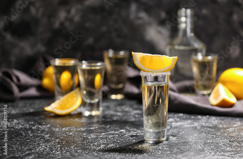 Shot of tasty tequila with lemon on dark background © Pixel-Shot