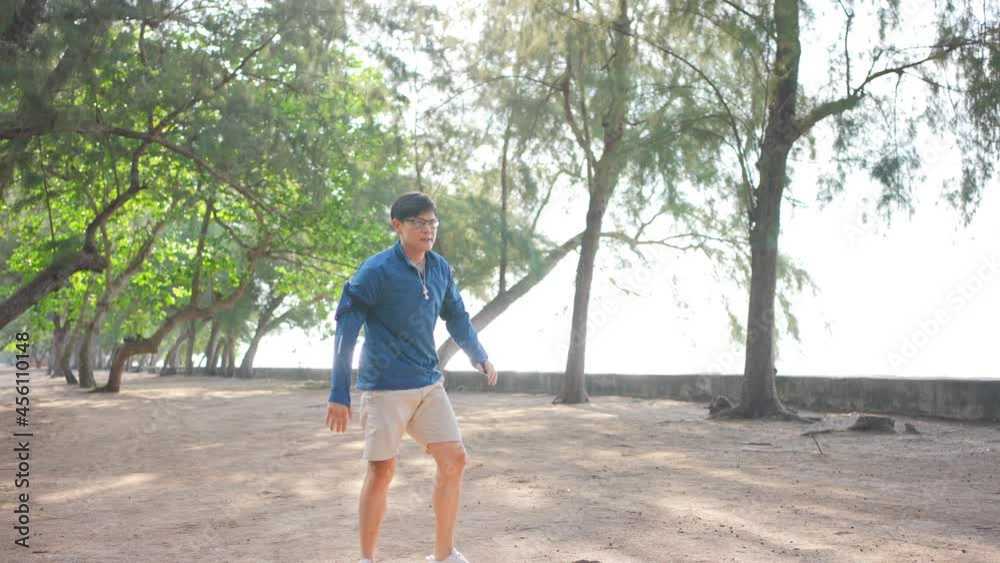 4K Healthy Asian man in sportswear jogging or running on the beach by the sea in summer morning. Strong athlete male do sport training workout fitness on the beach with listen to music from smartphone 4K Healthy Asian man in sportswear jogging or running on the beach by the sea in summer morning. Strong athlete male do sport training workout fitness on the beach with listen to music from smartphone