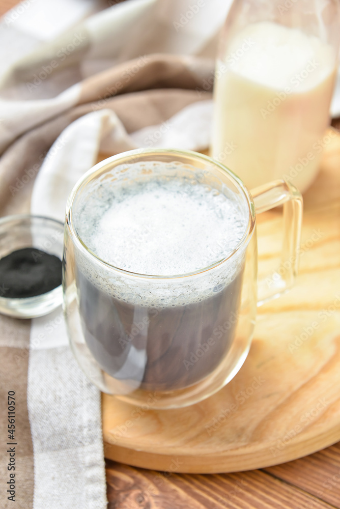 Glass cup of tasty Charcoal Latte on table Glass cup of tasty Charcoal Latte on table