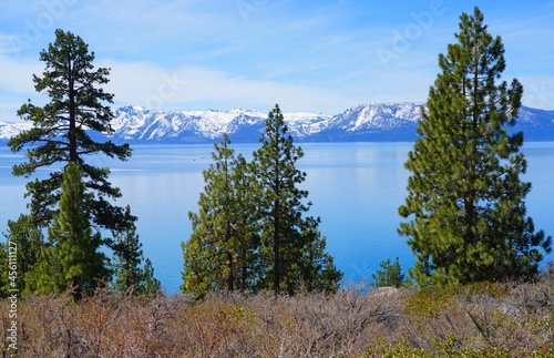 Landscape view of Lake Tahoe with snow-covered mountains and forests