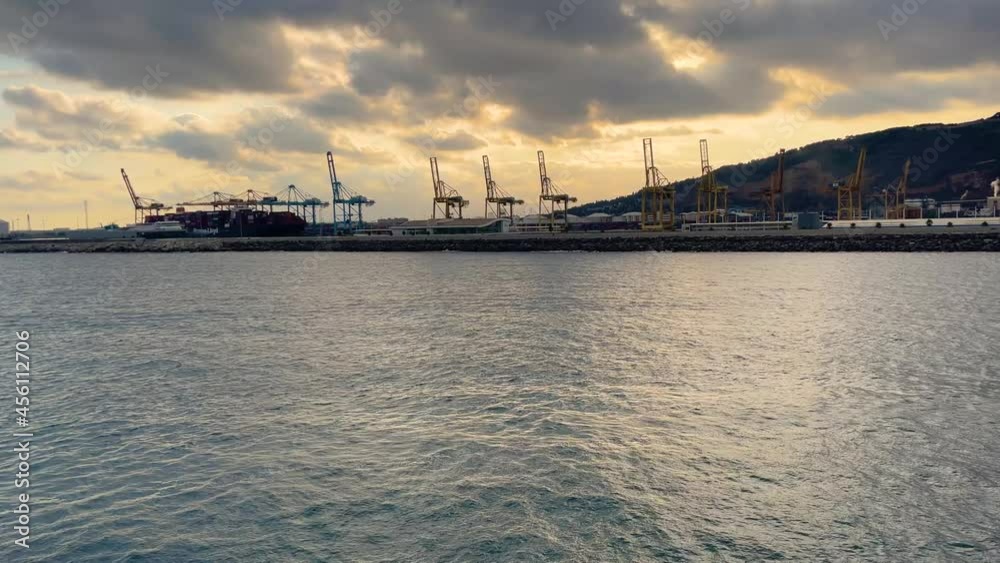 Port of Barcelona at sunset skyline Towers and cranes loading container ships passenger ferry Port of Barcelona at sunset skyline Towers and cranes loading container ships passenger ferry