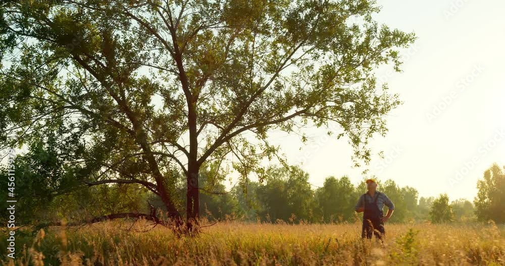 Portrait of a male farmer in a wheat field. The concept of agriculture, harvest, farming. Portrait of a male farmer in a wheat field. The concept of agriculture, harvest, farming.