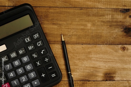 calculator next to pen ready to calculate