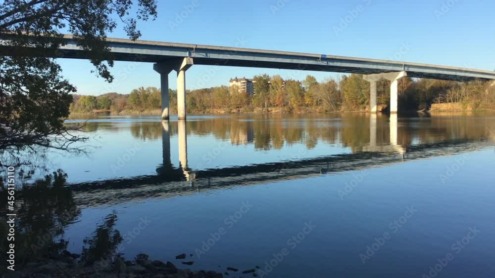 Panoramic view of bridge spanning large river with historic building in ...