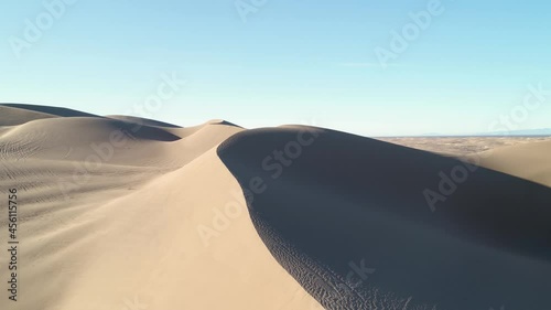 Aerial drone flight over sand dunes in the desert showing various textures photo