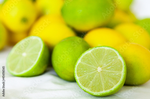 Fresh lime fruit harvest on white background, sliced open photo