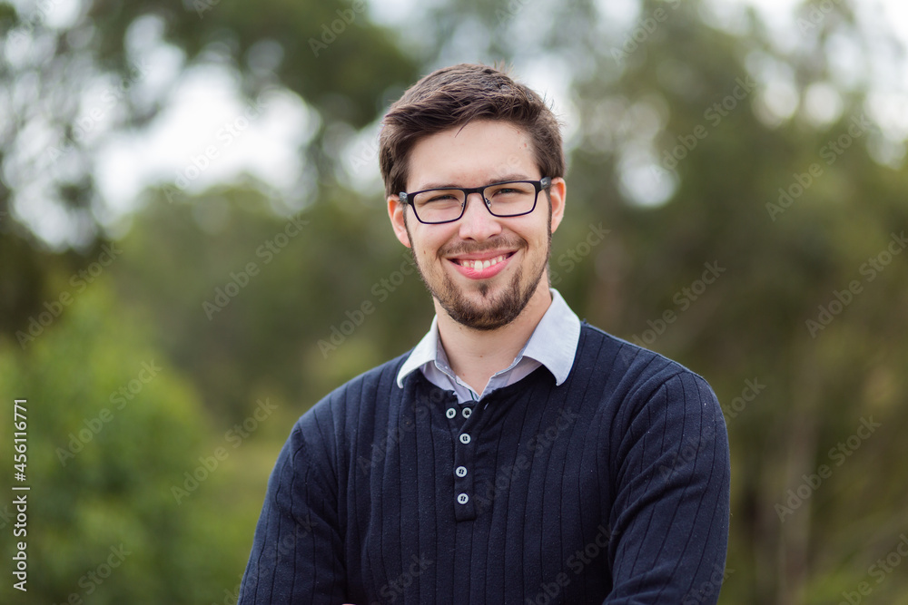 Portrait of smiling bearded man in his twenties outside Portrait of smiling bearded man in his twenties outside