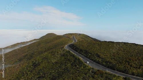 Drone shot of empty road high in the hills leading to the famous Cape Reinga New Zealand on a sunny summer morning in 4K. photo