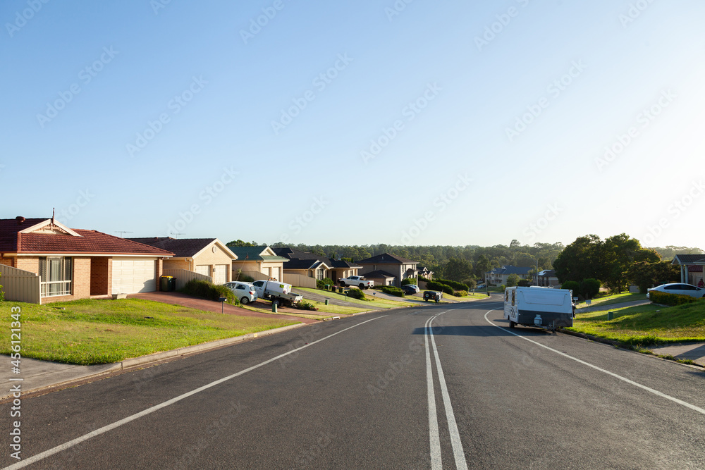 Houses along quiet Aussie suburban street in the morning light Houses along quiet Aussie suburban street in the morning light