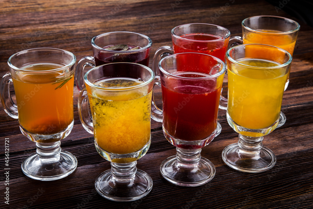 hot sweet teas with berries and herbs on a wooden background
hot sweet teas with berries and herbs on a wooden background