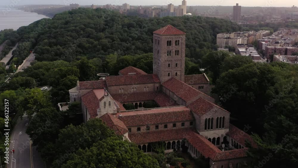 Close clockwise aerial orbit of The Cloisters museum in Upper Manhattan NYC with the neighborhood of Inwood in the morning haze in the background Close clockwise aerial orbit of The Cloisters museum in Upper Manhattan NYC with the neighborhood of Inwood in the morning haze in the background