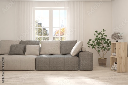 Stylish room in white color with sofa and autumn landscape in window. Scandinavian interior design. 3D illustration © AntonSh