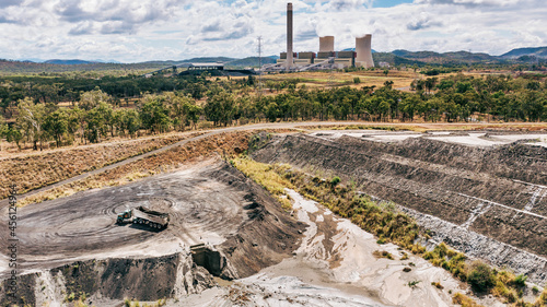 Horizontal shot of a tipper truck near Stanwell power station and ash piles photo