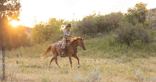Cowgirl wrangling horses © Terri Cage 