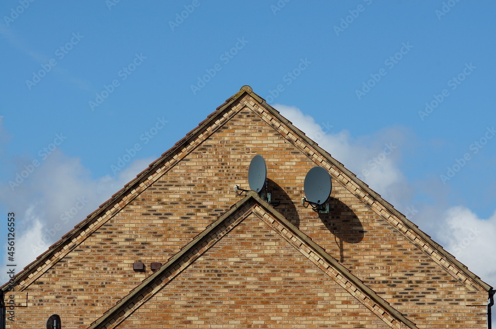 TV satelite dishes on side of modern house TV satelite dishes on side of modern house