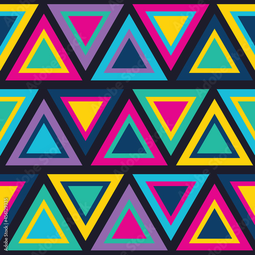 Bold geometric 80's triangle seamless vector pattern. Vibrant, bright and colourful triangular eighties retro style design. Blue, purple, pink, green, yellow 1980's background wallpaper texture print.