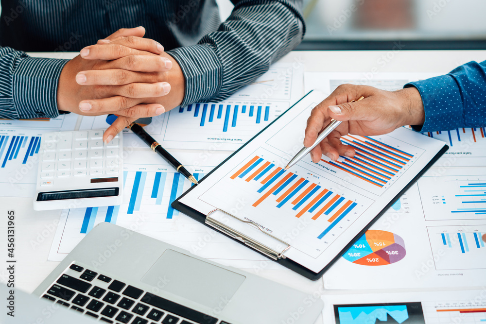Business executives cooperation in sale data performance report. Business executives cooperation in sale data performance report.