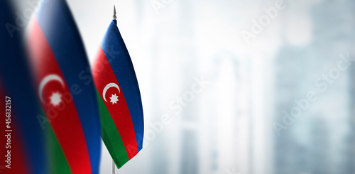 Small flags of Azerbaijan on a blurry background of the city