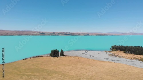 Beautiful drone shot of the turquoise blue water of famous Pukaki Lake in new Zealand on a clear sunney day in 4k. photo