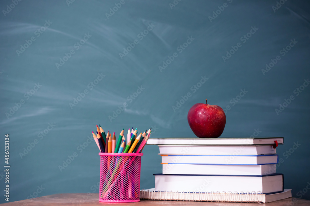 Pencils and book and blackboard. Education concept.