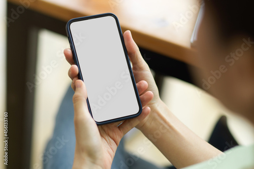 Close up, mobile blank screen mockup holding by young female, screen mockup © bongkarn