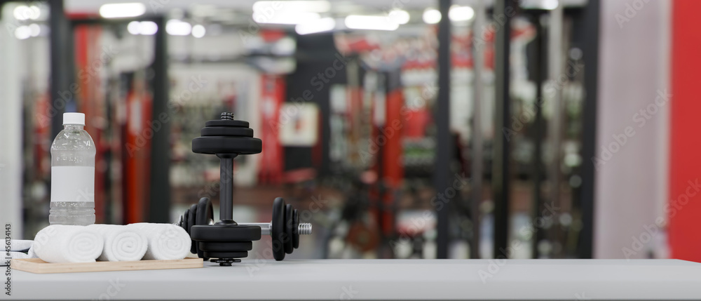 Fototapeta premium Dumbbells, drink bottle and towels on tabletop with space for product display over fitness gym background, 3d rendering