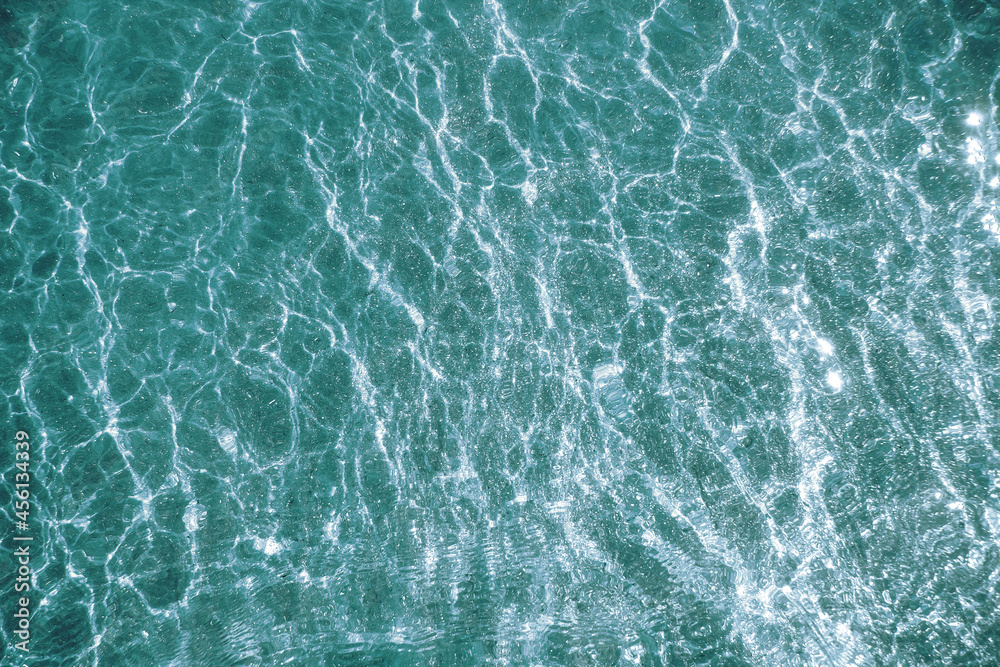 Green water and pouring mica through a layer of glitter water. A backdrop of the sea and ocean depth Green water and pouring mica through a layer of glitter water. A backdrop of the sea and ocean depth