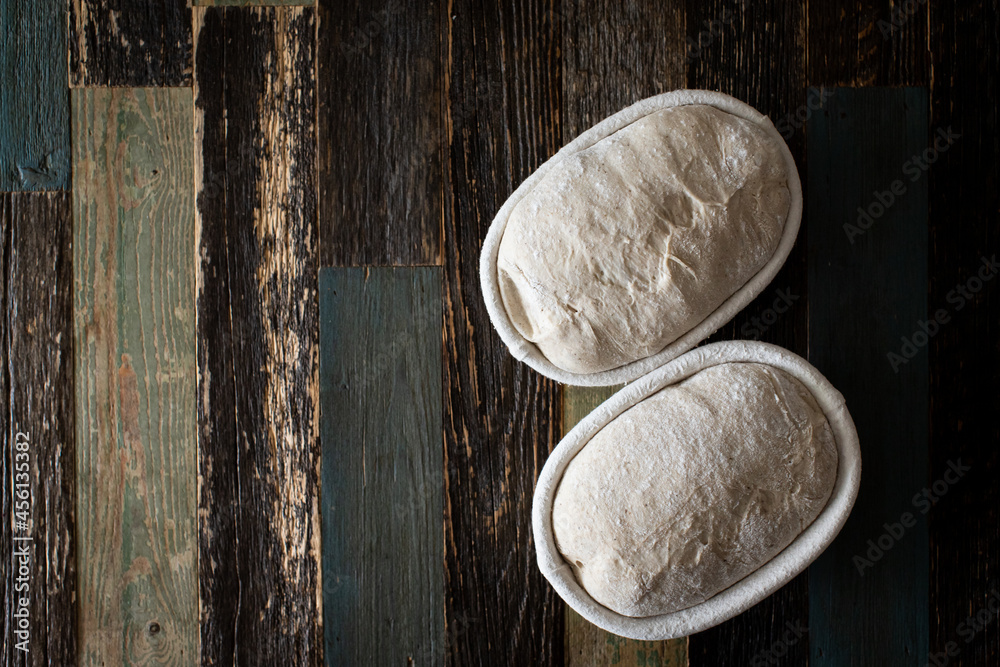 Bread dough in a rattan basket on a table made of wood Bread dough in a rattan basket on a table made of wood