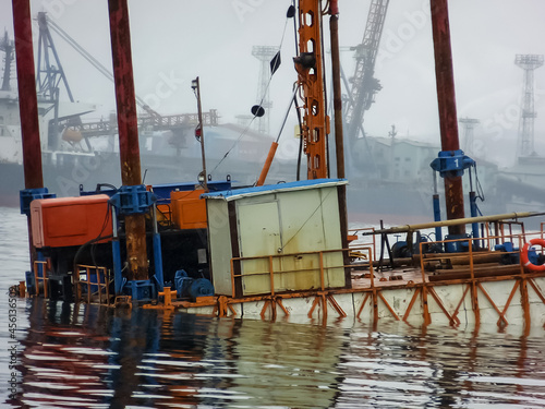 Drilling rocks on the sea coast. Piercing rig for oil exploration work on water and land.