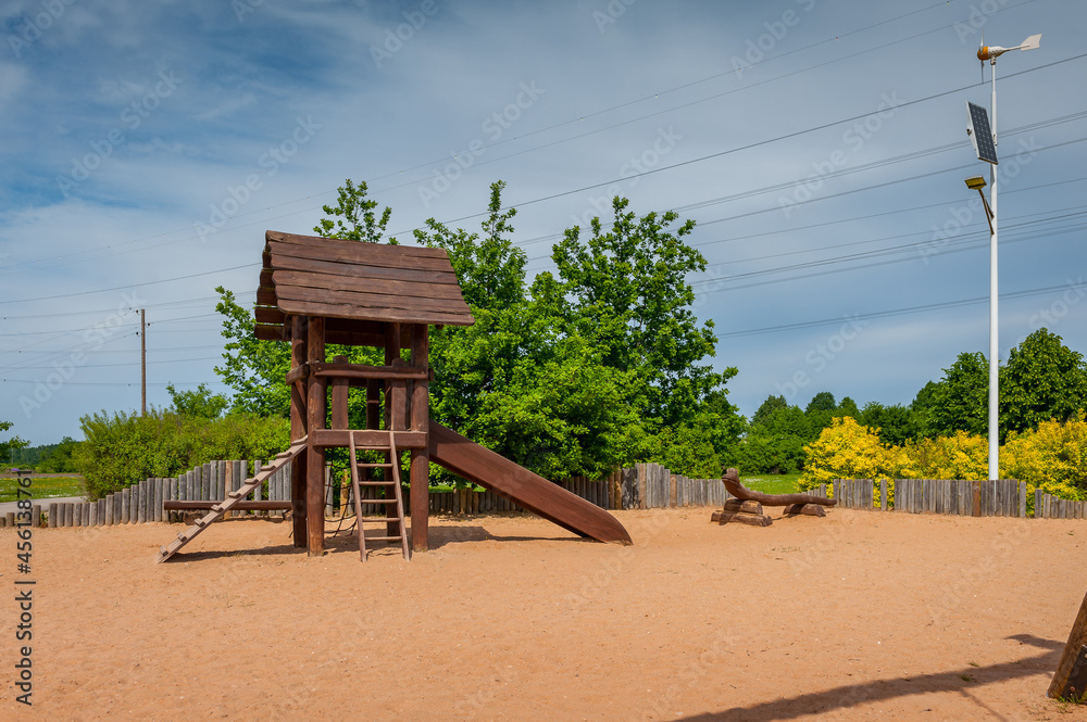 Children's playground equipped with wooden slides. A modern children's slide made of wood and natural materials. Children's playground equipped with wooden slides. A modern children's slide made of wood and natural materials.
