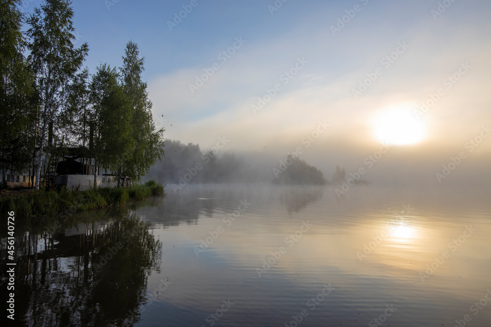 Dawn by the river in the summer season. Beautiful landscape of morning freshness.