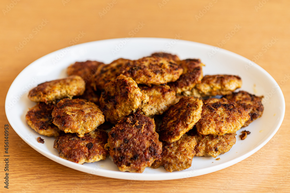 Homemade cutlets,meatballs white plate on a table yellow background.Delicious homemade cutlets.Selective focus.